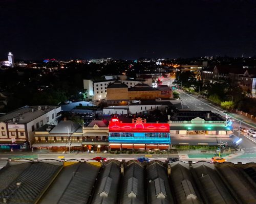 A view of a stanley facade aerial at night from the top of a building.